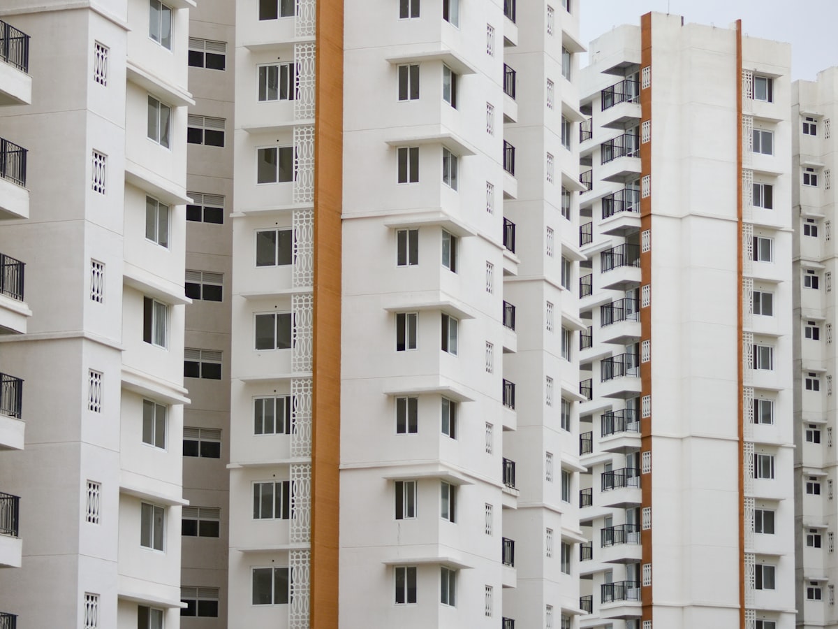 The facade of a white residential tower with projecting balconies
