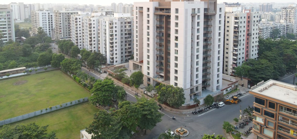 An aerial view of a residential neighbourhood of mid rise towers beside a playing field